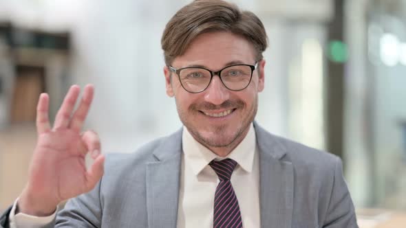 Portrait of Businessman Showing Ok Sign with Hand