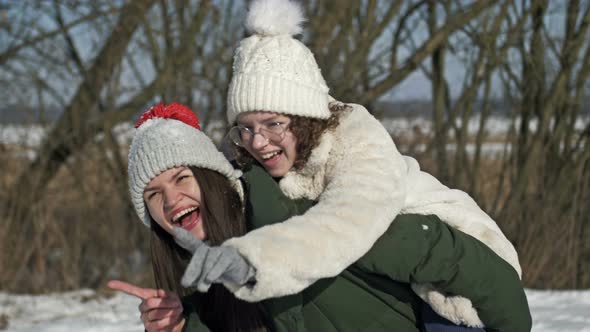 Mom and an Adult Daughter or Two Sisters are Having Fun During a Winter Walk