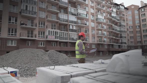 An Innovative Supervisor in Construction in Helmet and Wearer Checks Materials and Checks Quantity