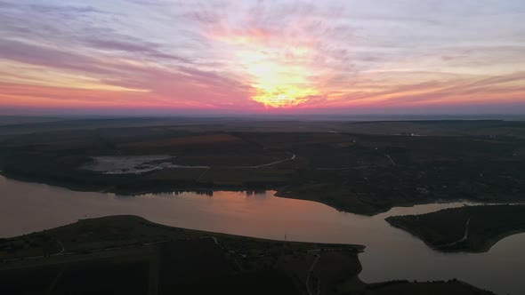 Aerial drone view of the Duruitoarea natural reservation at sunset in Moldova. River and village, hi