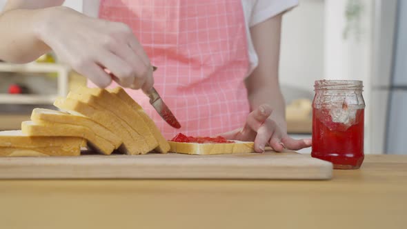 Close up of attractive woman making sandwich for breakfast to eat healthy food for health in house.