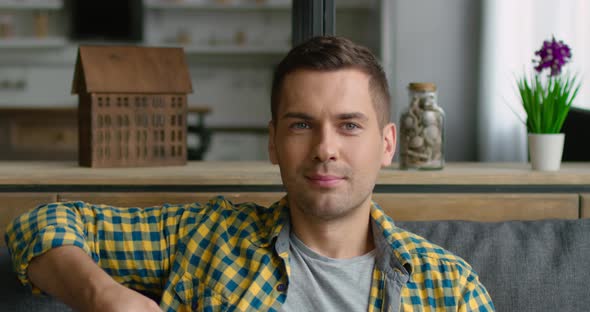 Young Man Is Relaxing at Home By Watching TV, Close Up