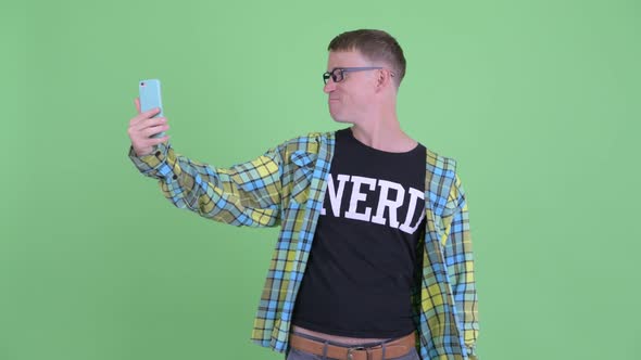 Portrait of Happy Nerd Man Video Calling with Phone