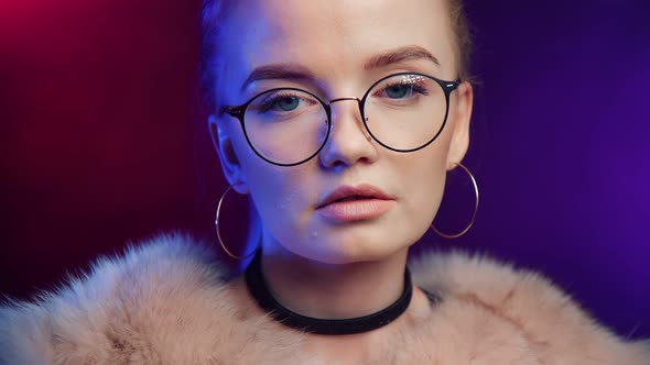 Face of Fashionable Young Girl in Glasses Posing at Night Party
