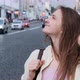 Young Woman Stands on Roadway Background and Looks Around - VideoHive Item for Sale