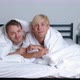 Young Gay Couple Lying on Bed Together in Bedroom Hugging and Kissing - VideoHive Item for Sale