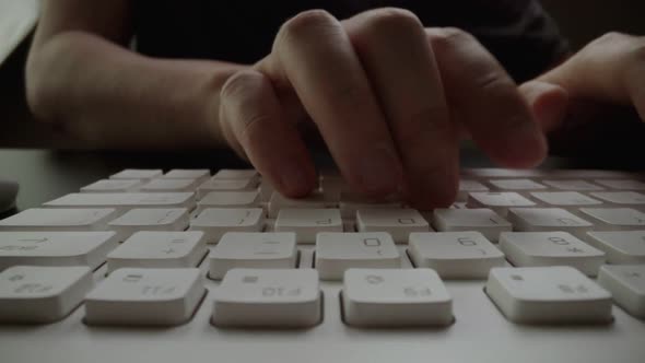 Closeup Typing on Keyboard with Man Fingers