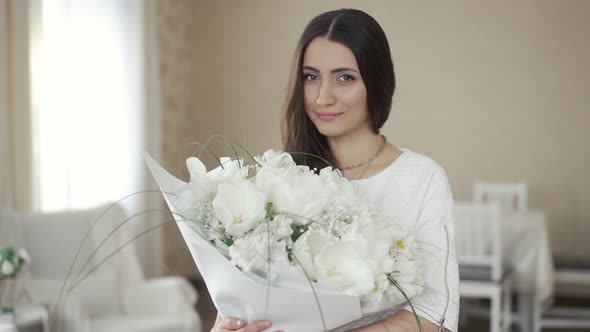 Beautiful Woman with White Flowers at Home