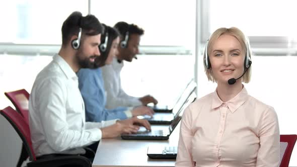 Blond Cheerful Woman in Office Showing Okay Gesture.