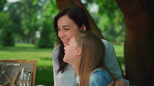 Mother Laughing with Daughter on Picnic Closeup