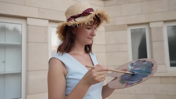 Young Talented Woman Imitating Painting on Camera in Slow Motion