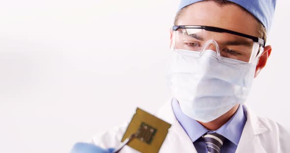 Technician repairing motherboard chip