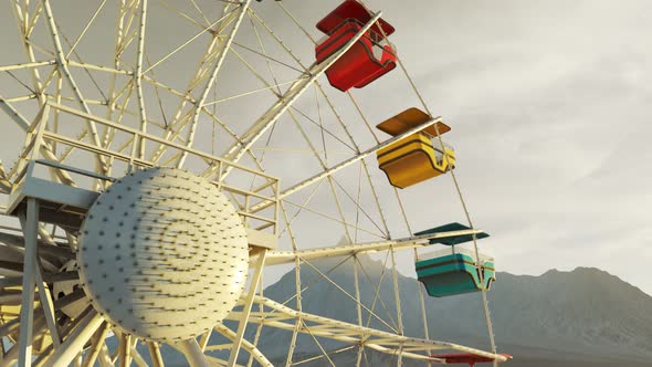 Colorful Ferris wheel spinning slowly in a mountain landscape in endless loop.