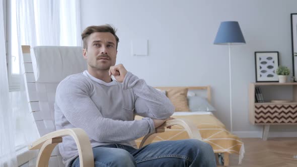 Thinking Middle Aged Man Sitting on Casual Chair Brainstorming