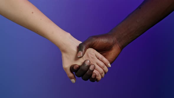 Hands of African Man and White Woman Holding Together, As Symbol of Interracial Friendship. Isolated