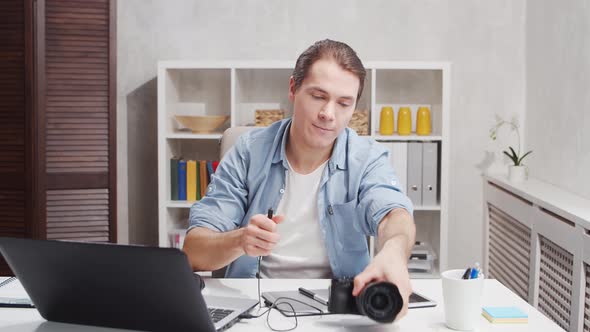 Workplace of freelance worker at home office. Young man works using computer.