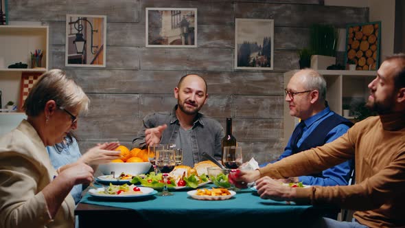 Mother and Father in Their Sixties Clinking Glasses of Red Wine