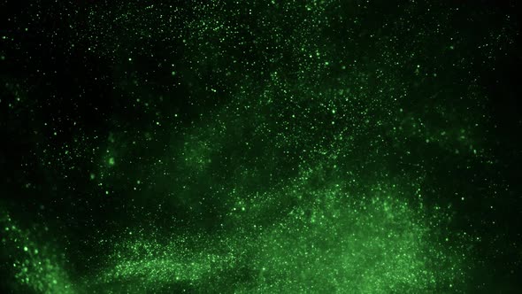 The Explosion of Green Particles on a Black Background