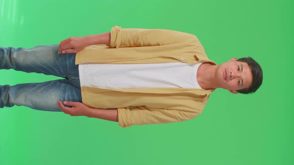 Asian Man Looking At Camera In The Green Screen Studio