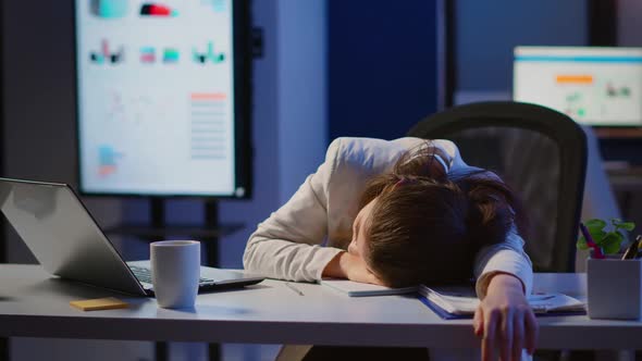 Freelancer Working Overtime Falling Asleep with Hand on Financial Documents