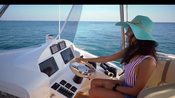 Cheerful Young Woman Riding White Pleasure Craft Having Rest  Spending Sunny Day on Yacht