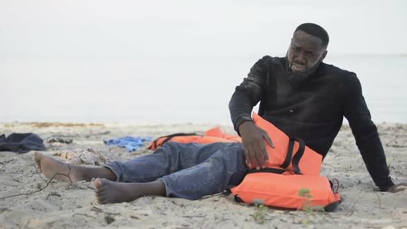Black Man Crying Hugging Life Jacket, Survived Plane Crash on Deserted Island