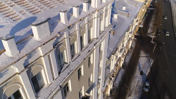 Multistory Building with Snowy Cornices and Arch Windows