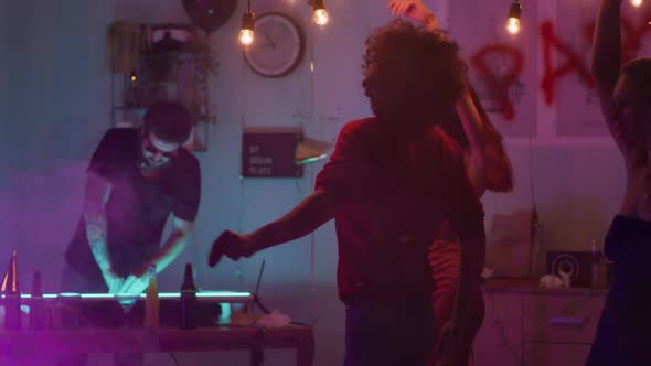 Young Man Dancing in Smoke During Party