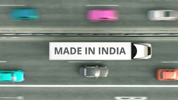 Trailer Trucks with MADE IN INDIA Text Driving Along the Road