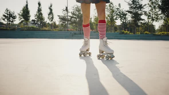 Close Up of Female Legs in Striped Kneehighs Rollerblading in Urban Park Young Woman Enjoying Riding