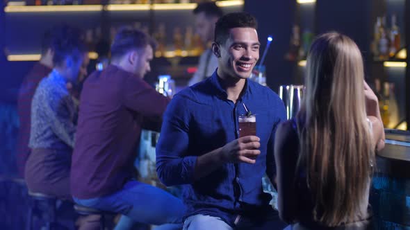 Handsome Arab Man Conversating with Woman at Bar