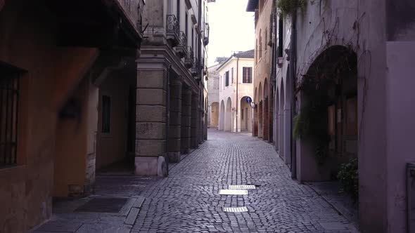 Local City Buildings with Large Brick Arches and Paved Road