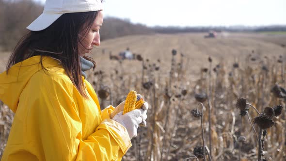 Young Woman Farmer Standing on Corn Field During Harvesting