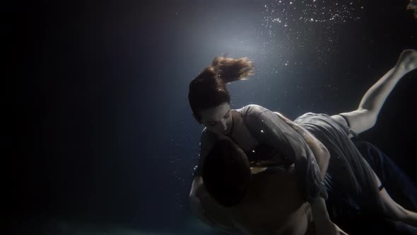 Young Man and Woman Are Swimming Underwater and Embracing Romantic and Love of Couple