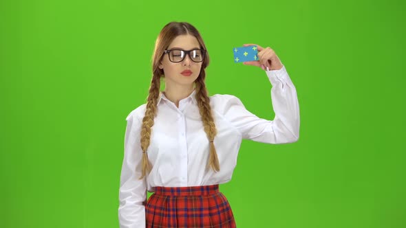 Teen in Glasses Raises a Card and Shows a Ok . Green Screen