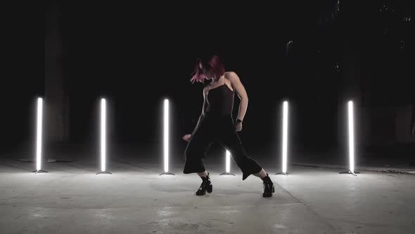 Stylish Woman Dancing with Light Stands at Background