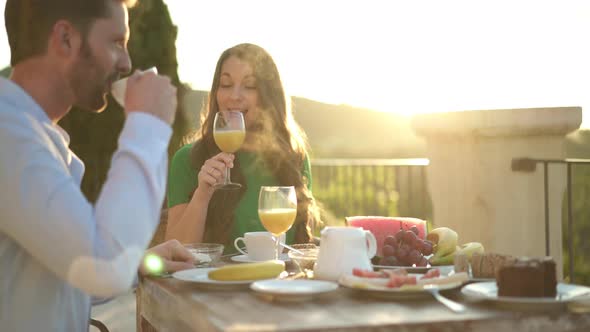 Well Dressed Couple Having Breakfast Outside