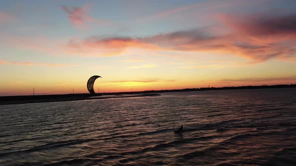 Stunning Colorful Sky During Sunset and a Kitesurfer Gliding on the Water