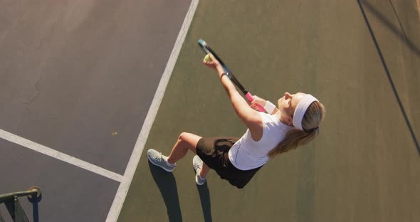 Video of top view of caucasian female tennis player holding racket and hitting ball