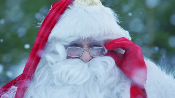 Close up of Santa arranging his glasses