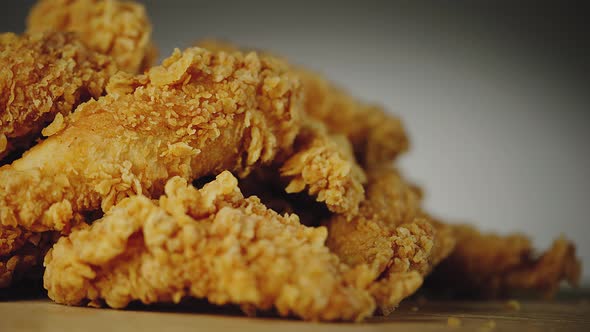 Stack of Crispy Fried Chicken Parts Placed on Wooden Board