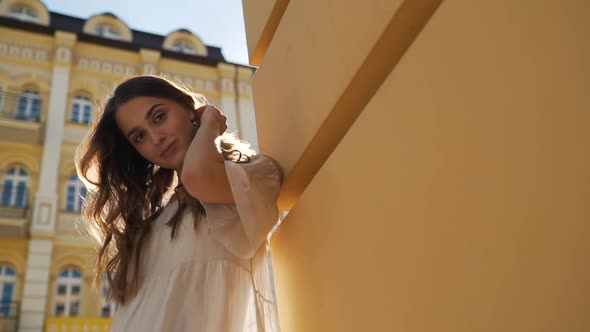 Beautiful Girl Smiles on the Background of the Old City