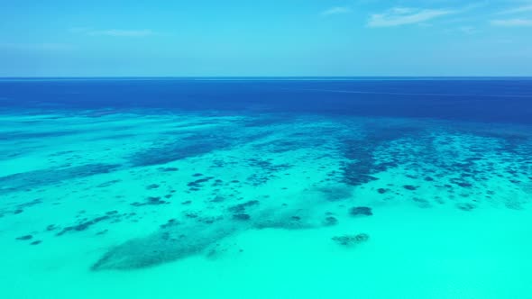 Aerial above nature of tranquil shore beach voyage by blue green lagoon and white sand background of