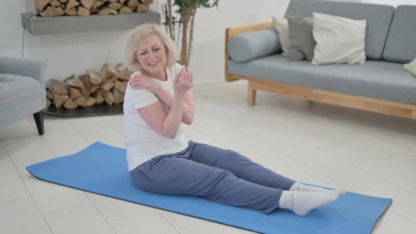 Senior Old Woman Having Shoulder Pain While Doing Yoga at Home