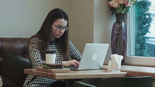 Woman on Lunch Break in Cafe Drinks Coffee Use Laptop