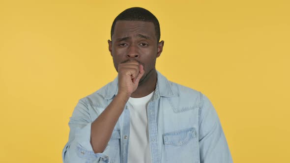 Sick Young African Man Coughing, Yellow Background 