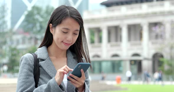 Asian Woman use of cellphone in city