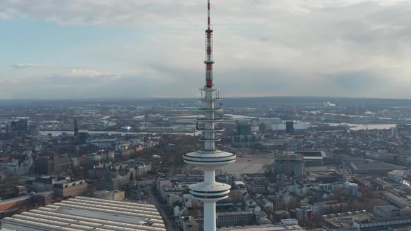 Aerial Dolly Out View of Tall White Heinrich Hertz TV Tower Rising Above Hamburg Cityscape