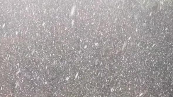 Falling upwards snowflakes during winter snowfall. Abstraction. alt