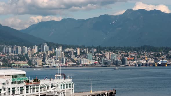 Helicopter Flight Over Vancouver Harbour With SeaBus And Cityscape Of North Vancouver In Canada. - w